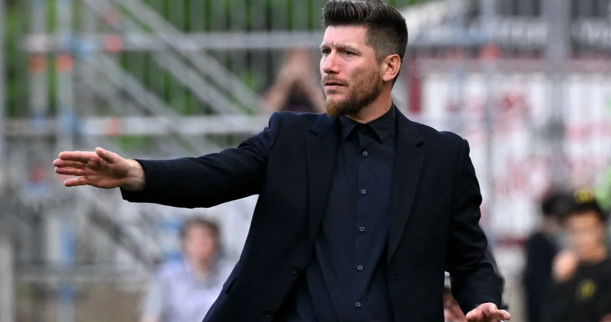 Coach giving instructions on the sidelines during match
