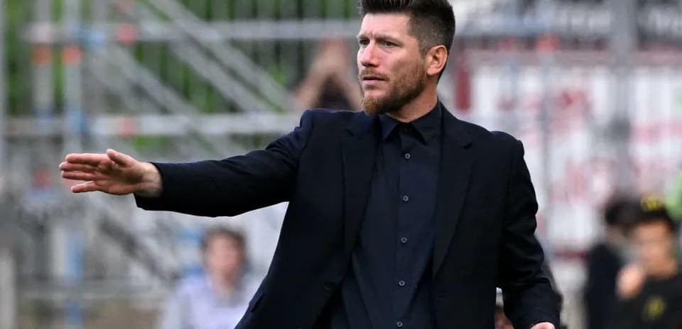 Coach giving instructions on the sidelines during match
