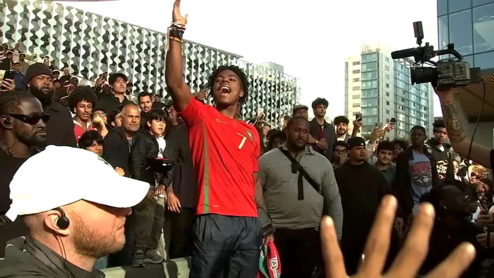 Fan in Portugal jersey celebrating with crowd