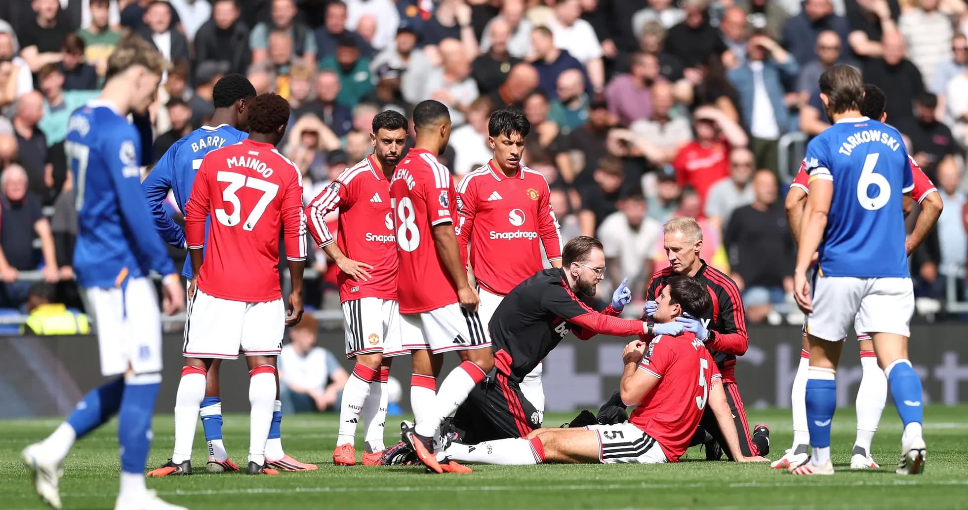 Medical staff attending to injured player on pitch