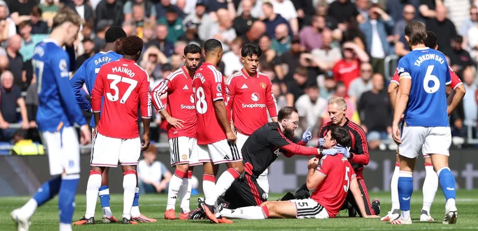 Medical staff attending to injured player on pitch