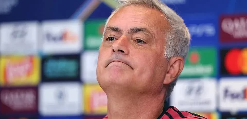 Manager at press conference with Champions League backdrop