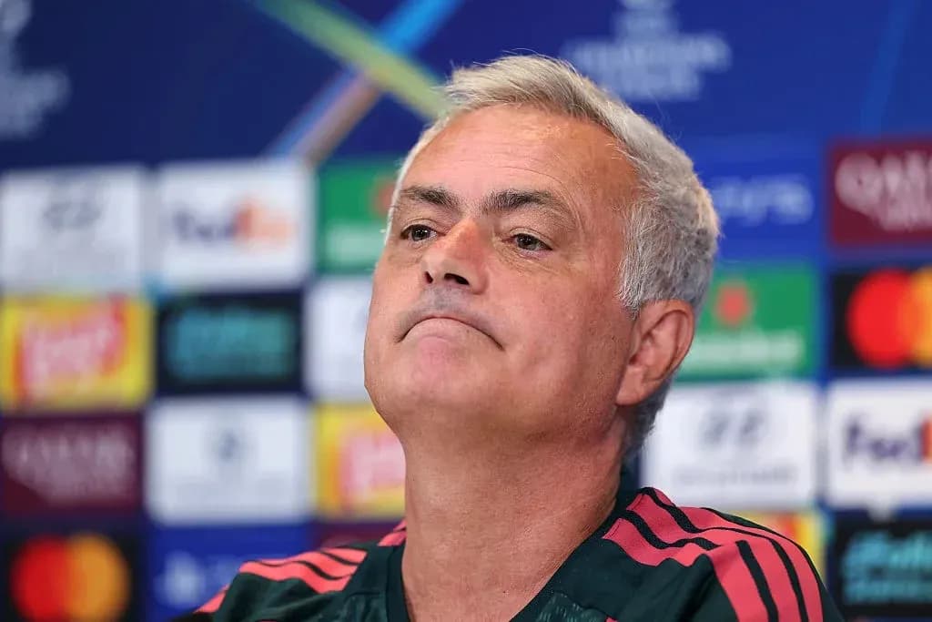 Manager at press conference with Champions League backdrop