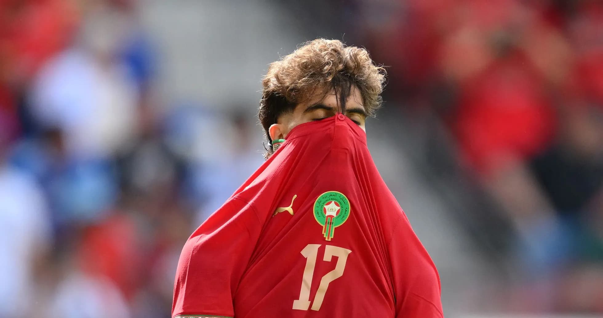 Player covering face with jersey during match