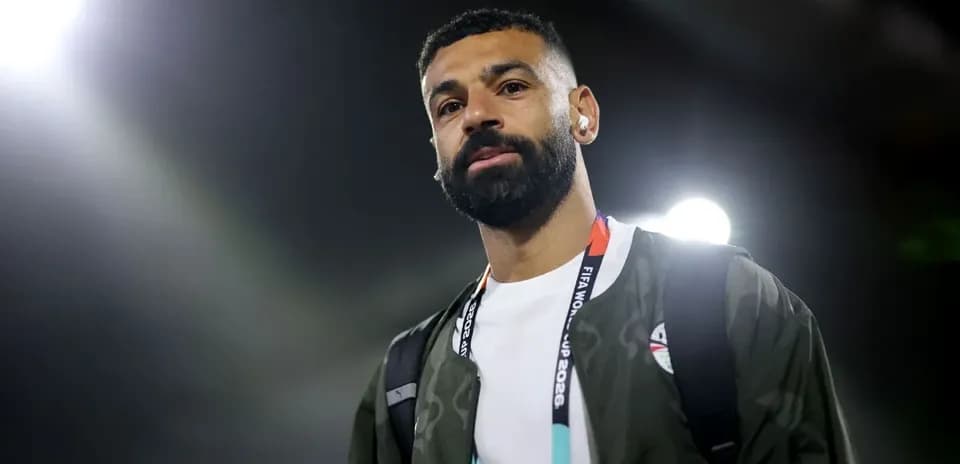 Player walking with headphones at a stadium