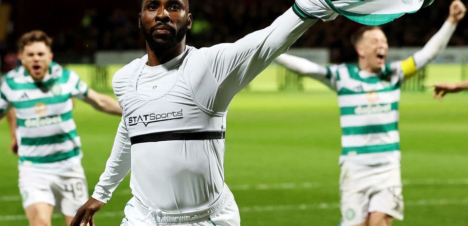 Player celebrating a goal with teammates on field