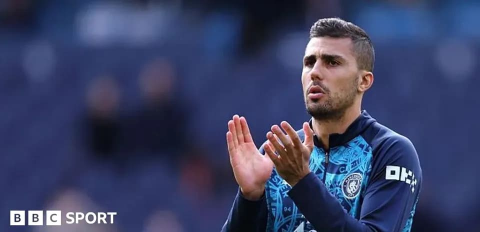 Player applauding fans during warm-up on pitch
