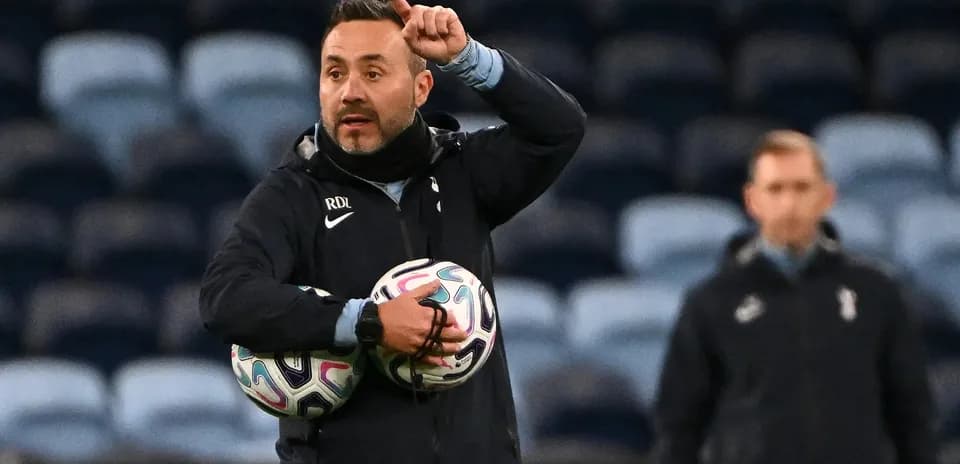 Coach instructing players while holding training balls