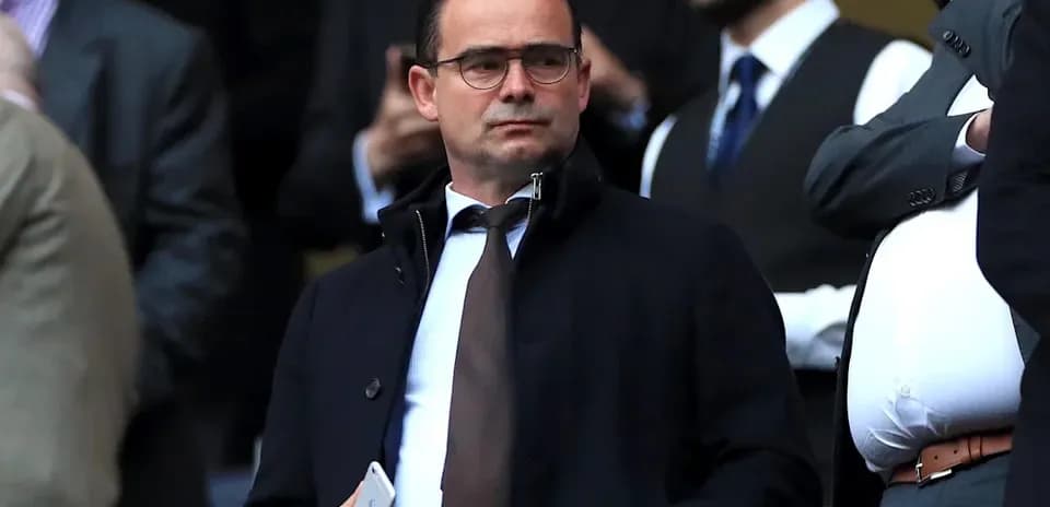 Man in suit observing the event from stands
