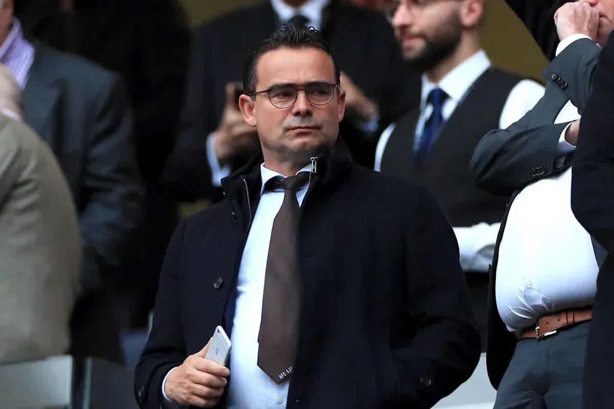 Man in suit observing the event from stands