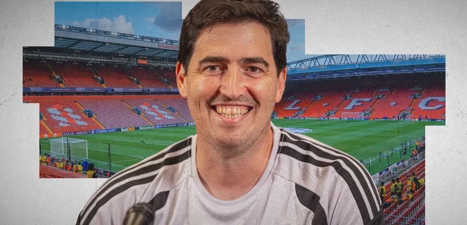 Person smiling in front of Anfield stadium backdrop