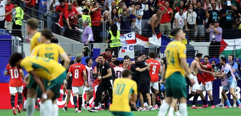 Players celebrating a victory with fans in stadium