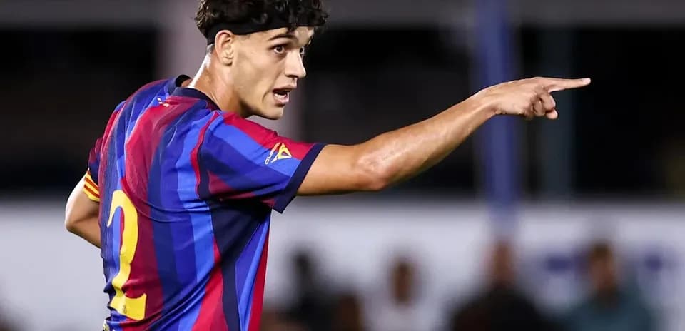 Player in FC Barcelona jersey directing teammates on field