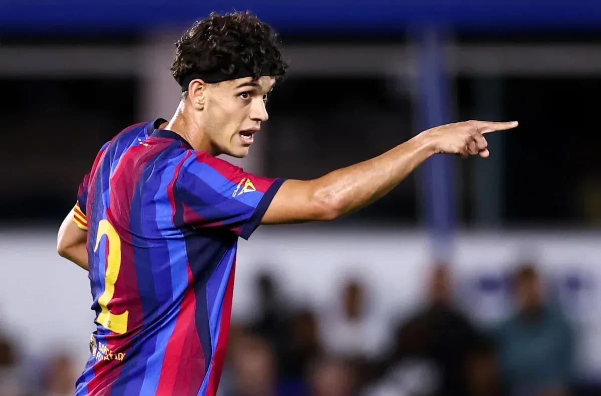 Player in FC Barcelona jersey directing teammates on field