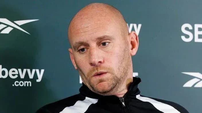 Coach speaking at a press conference