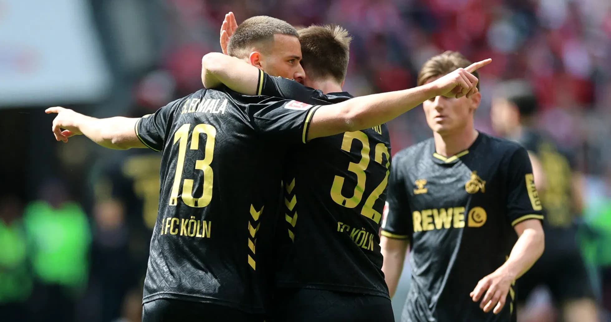 Two FC Köln players celebrating a goal together