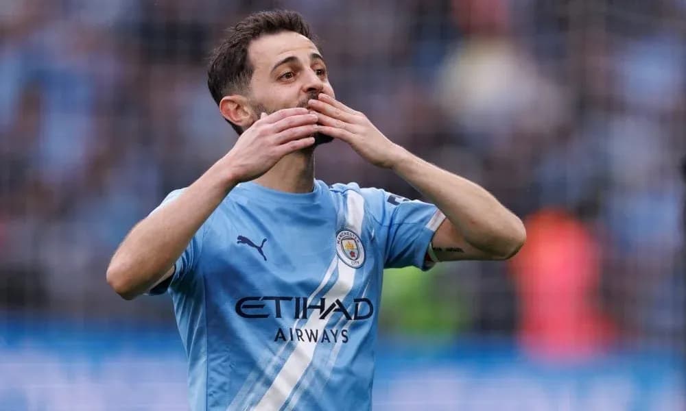 Player celebrating in Manchester City jersey on field