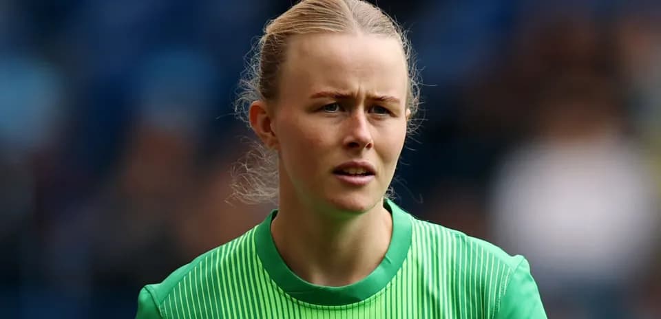 Goalkeeper in green kit during match warm-up