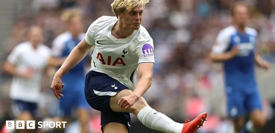 Tottenham player kicking ball during match