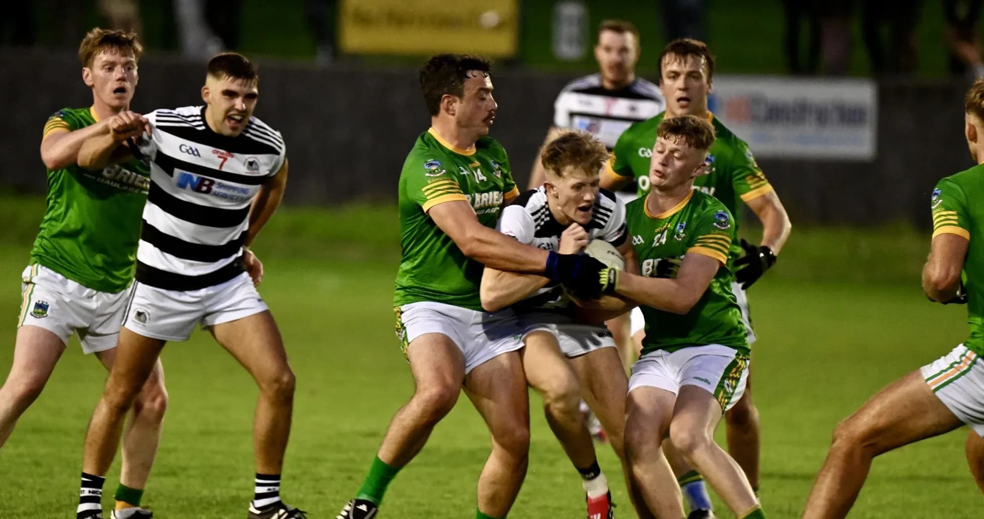 Players contesting possession during a Gaelic football match