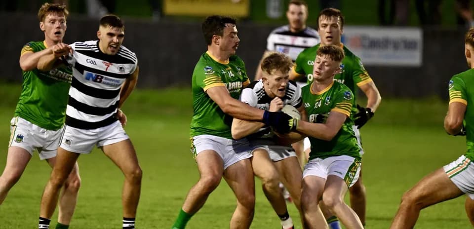 Players contesting possession during a Gaelic football match