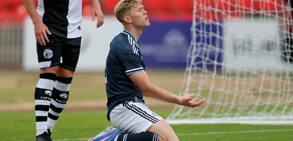 Player kneeling in front of goal during match