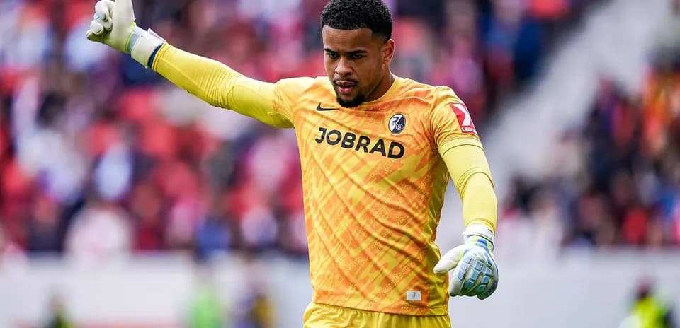 Goalkeeper gesturing during match in yellow kit