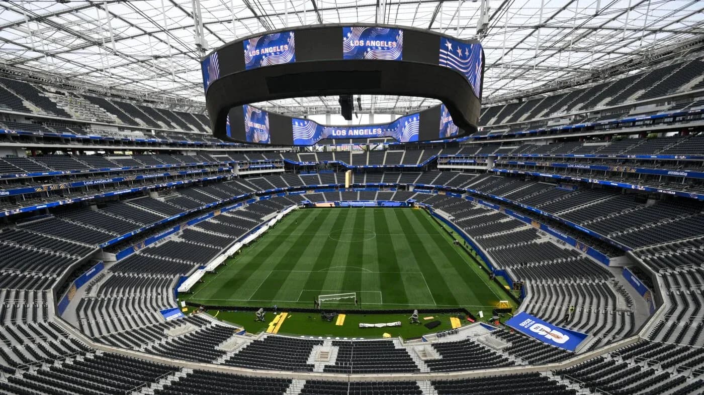 Empty stadium interior with a green soccer field
