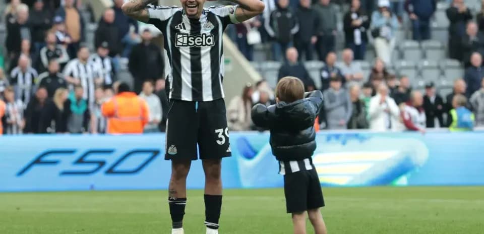 Newcastle player celebrating with a young fan