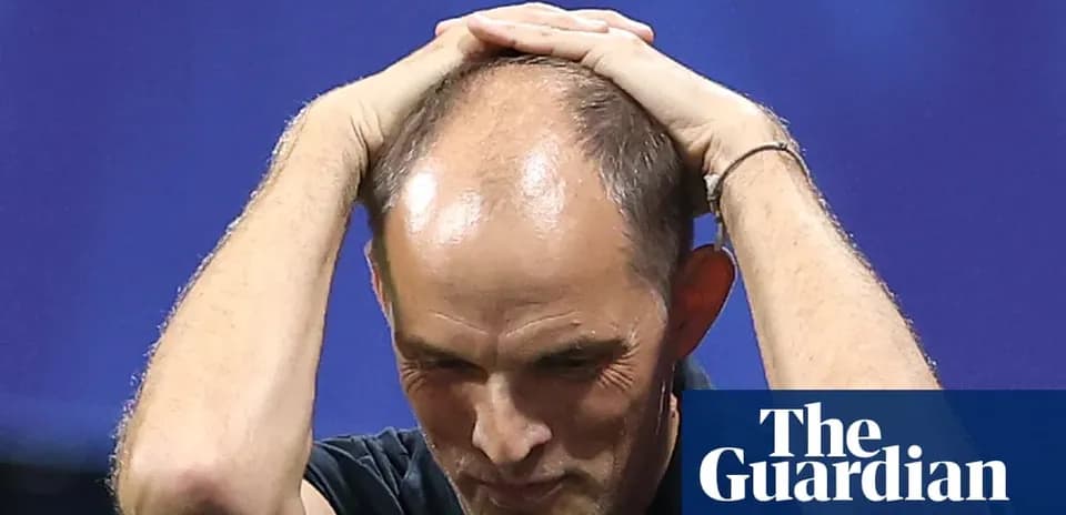Coach holding head during tense moment on field