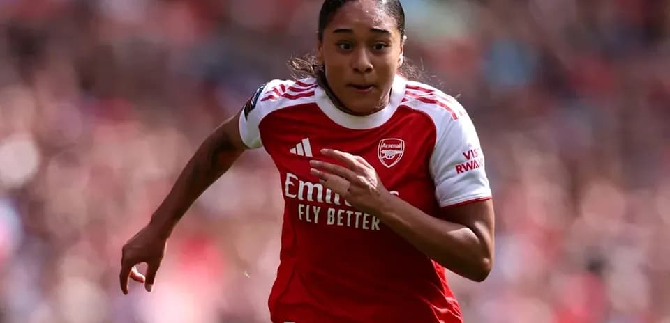 Player sprinting in Arsenal jersey during match
