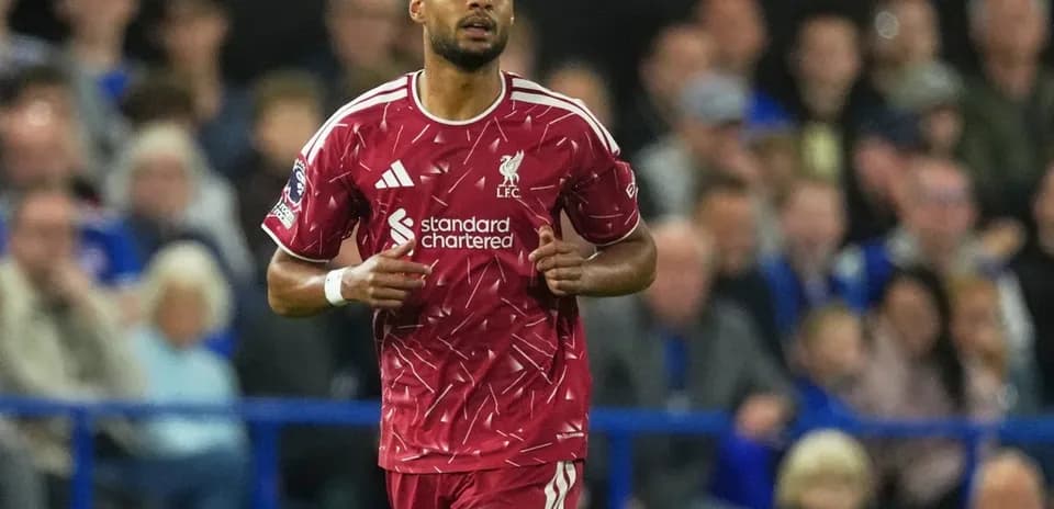 Liverpool player running on pitch during match
