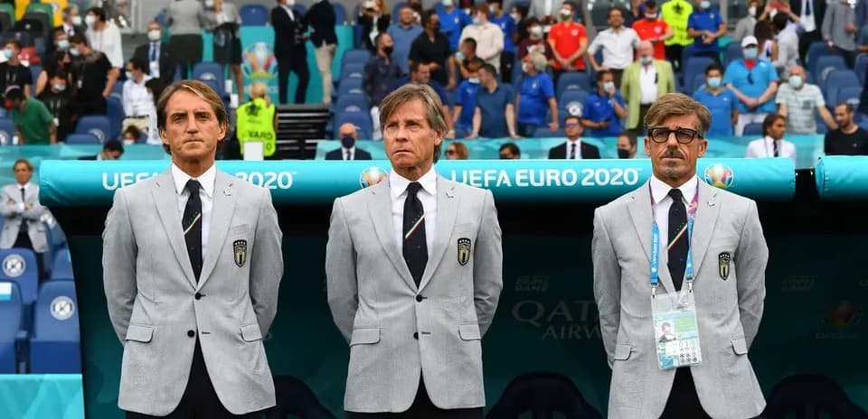 Coaching staff standing on the sidelines during match