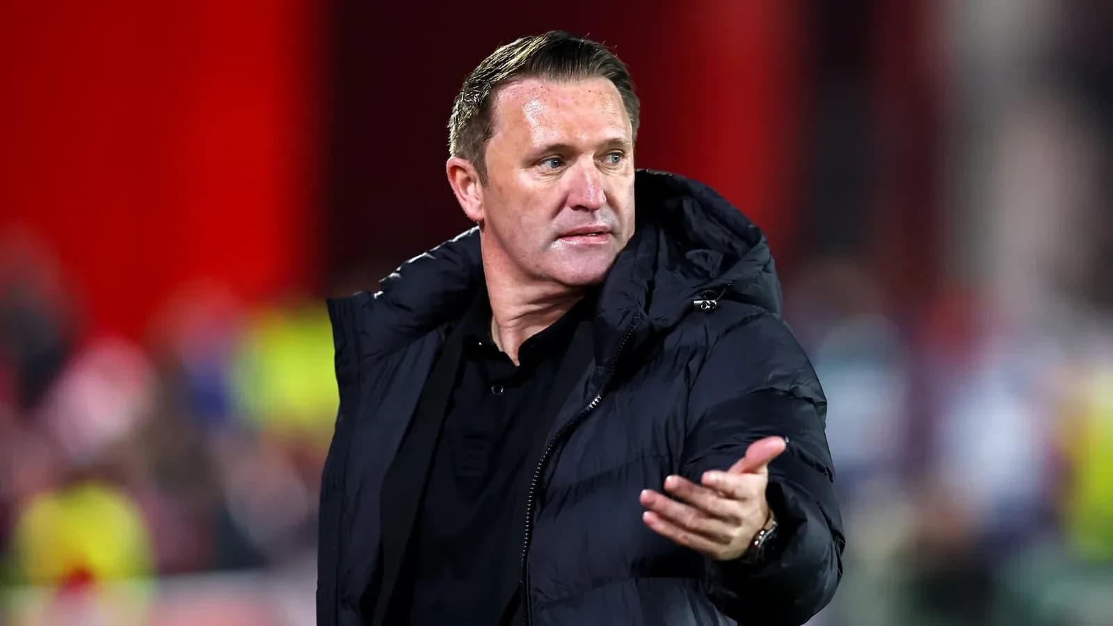 Manager gesturing during a football match