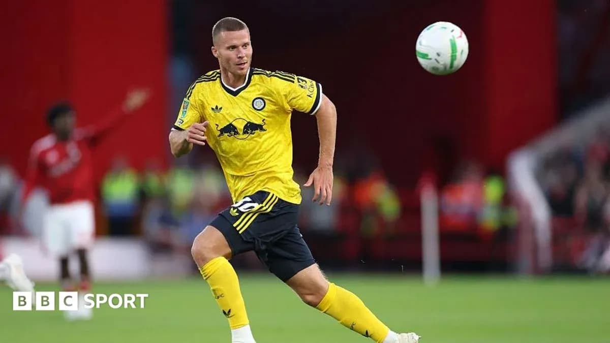 Player in yellow kit chasing a soccer ball
