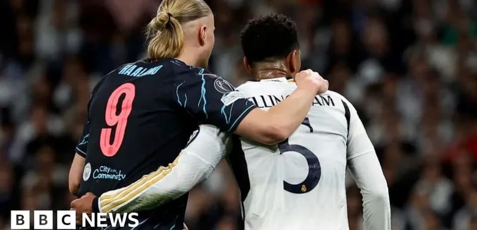 Two players embracing on the football pitch