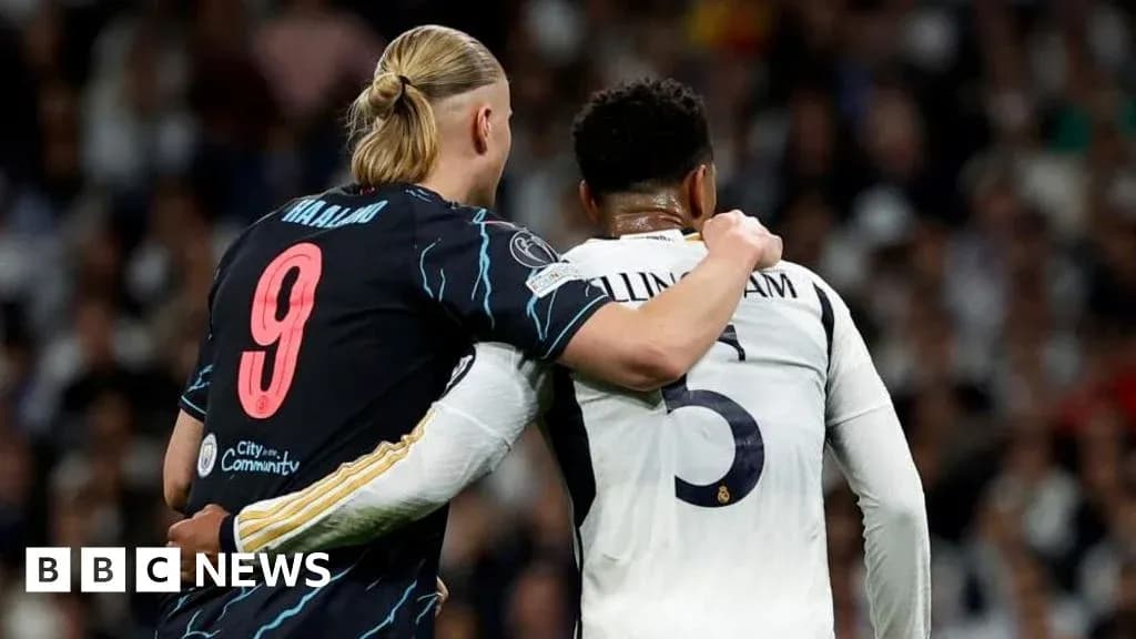 Two players embracing on the football pitch