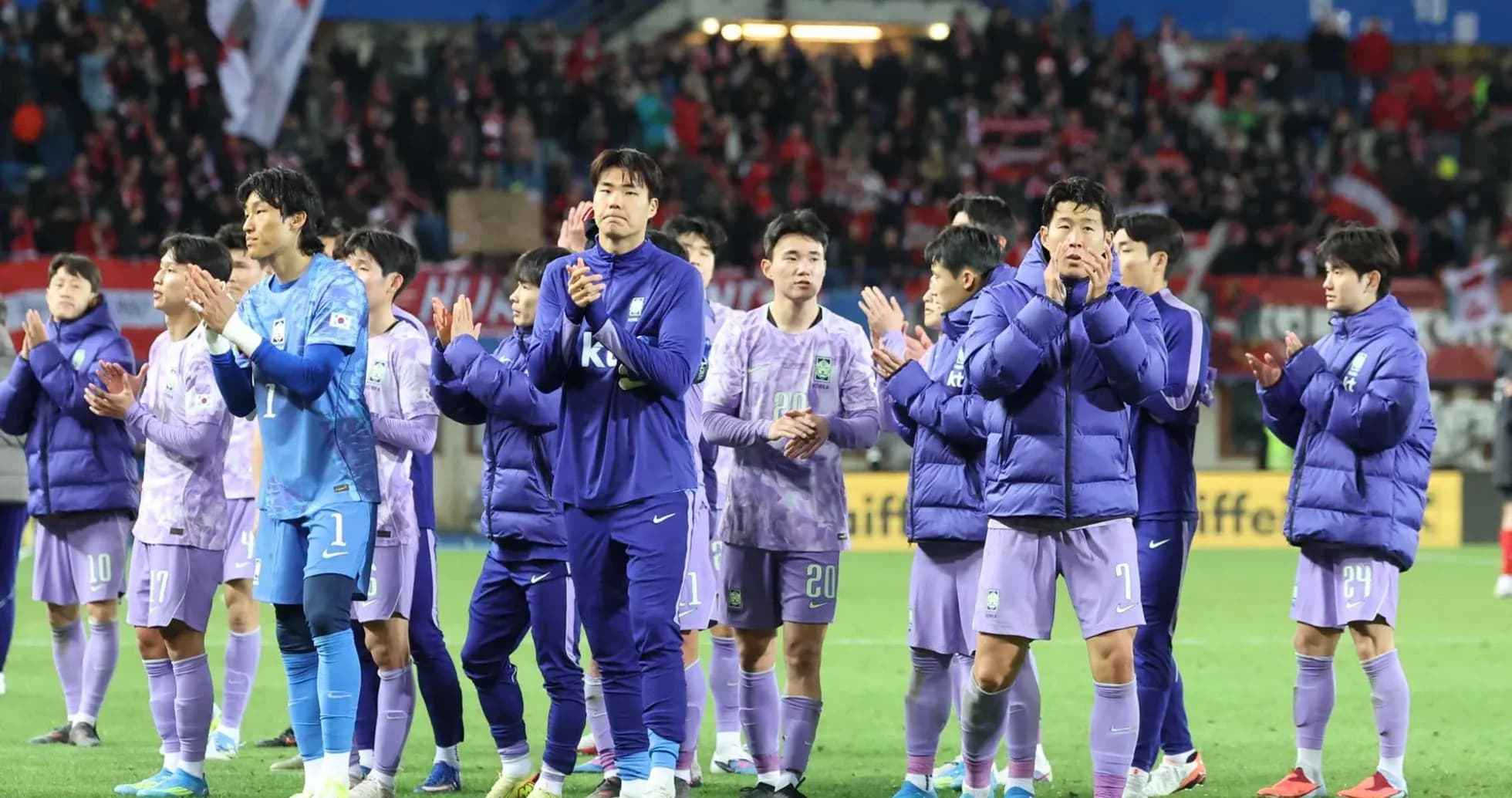 Team applauding fans after a match