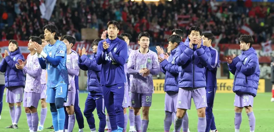 Team applauding fans after a match