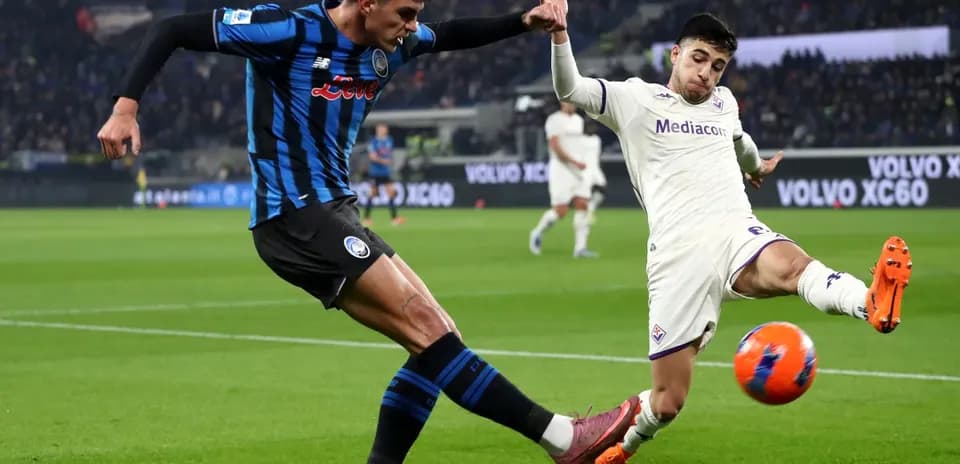 Fiorentina player challenges Atalanta opponent for the ball