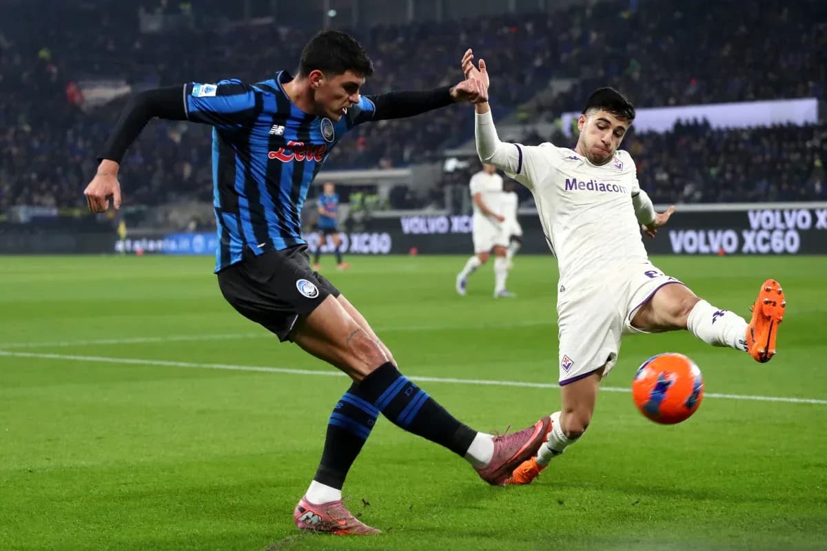 Fiorentina player challenges Atalanta opponent for the ball