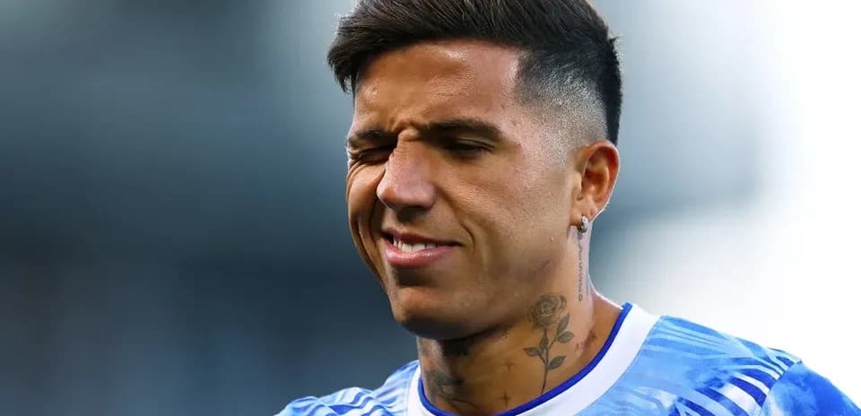 Player with tattoos smiling during warm-up session