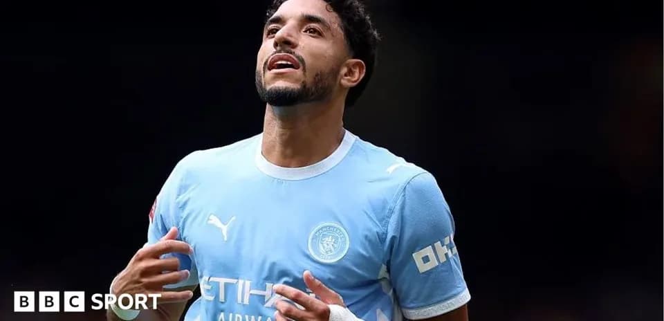 Player celebrating in Manchester City kit on field