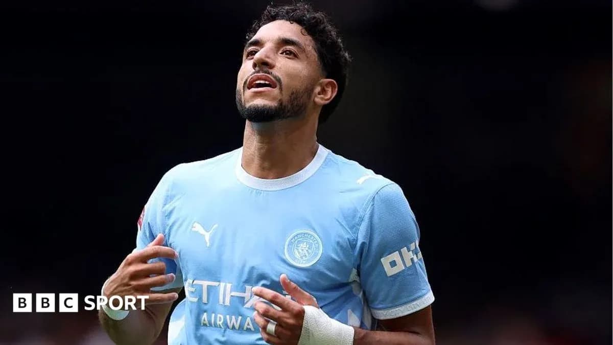 Player celebrating in Manchester City kit on field