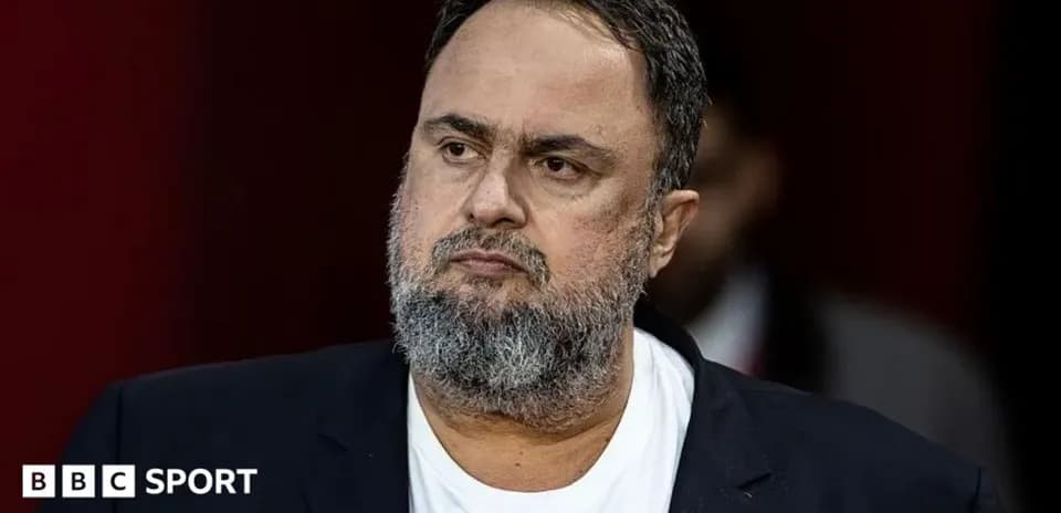 Man in a suit with a beard looking serious