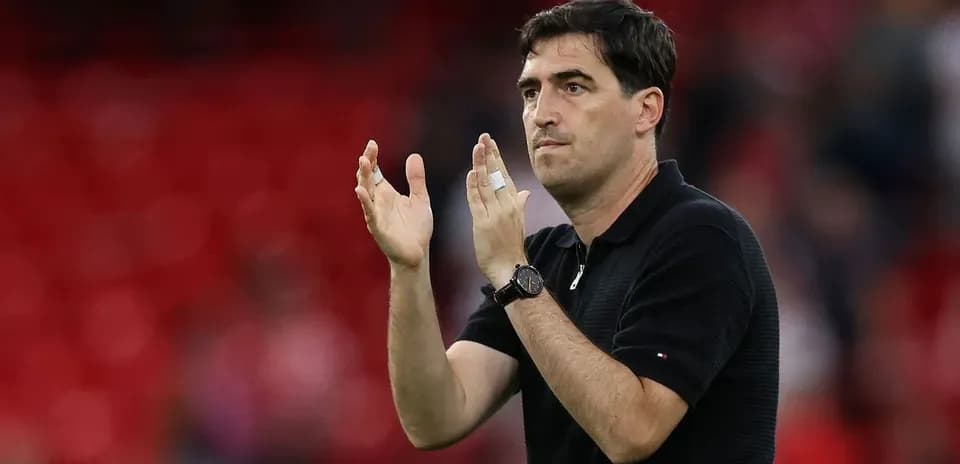 Coach gesturing and applauding on the sidelines