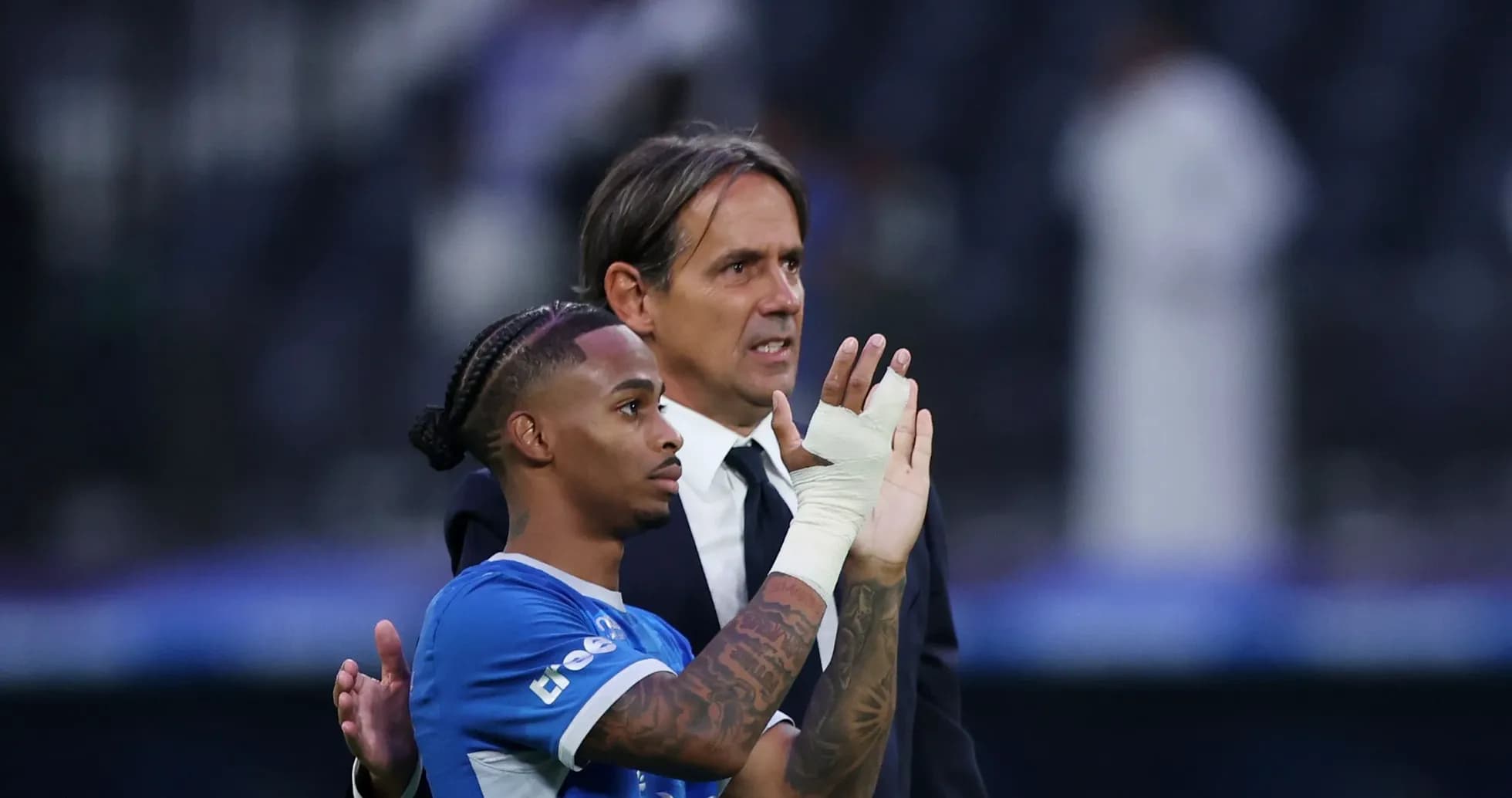 Player and coach acknowledging fans after match