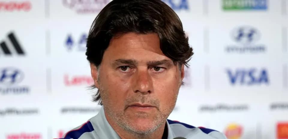 Coach speaking at a press conference podium