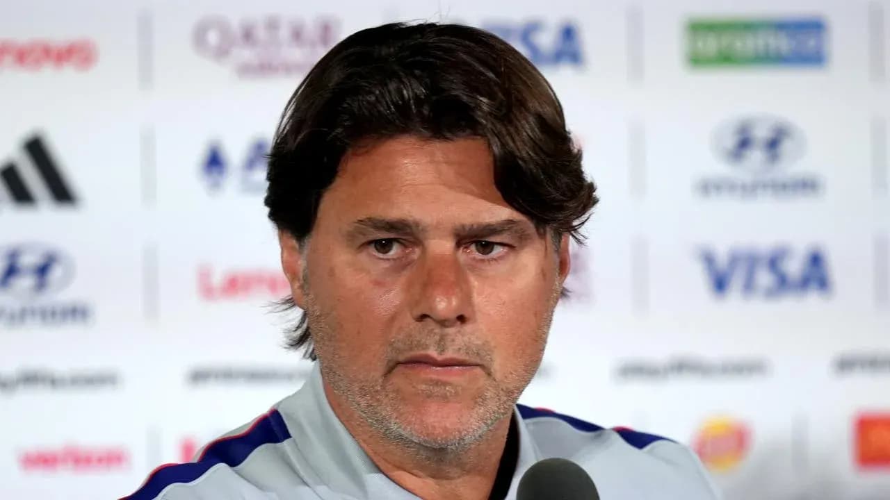 Coach speaking at a press conference podium
