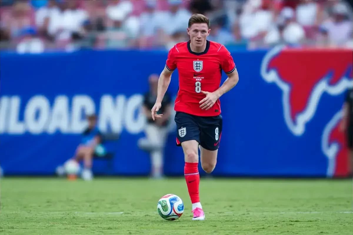 Player in red jersey running with soccer ball